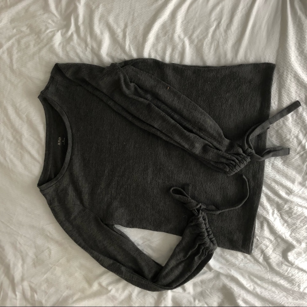 grey sweater with design on sleeves